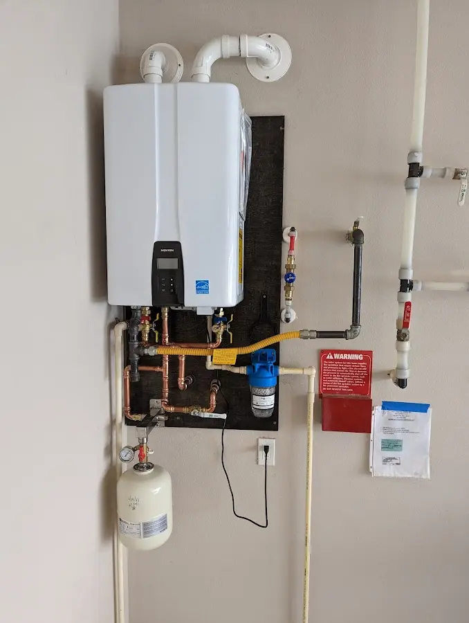 Professional plumber installing copper piping in a Schriever home